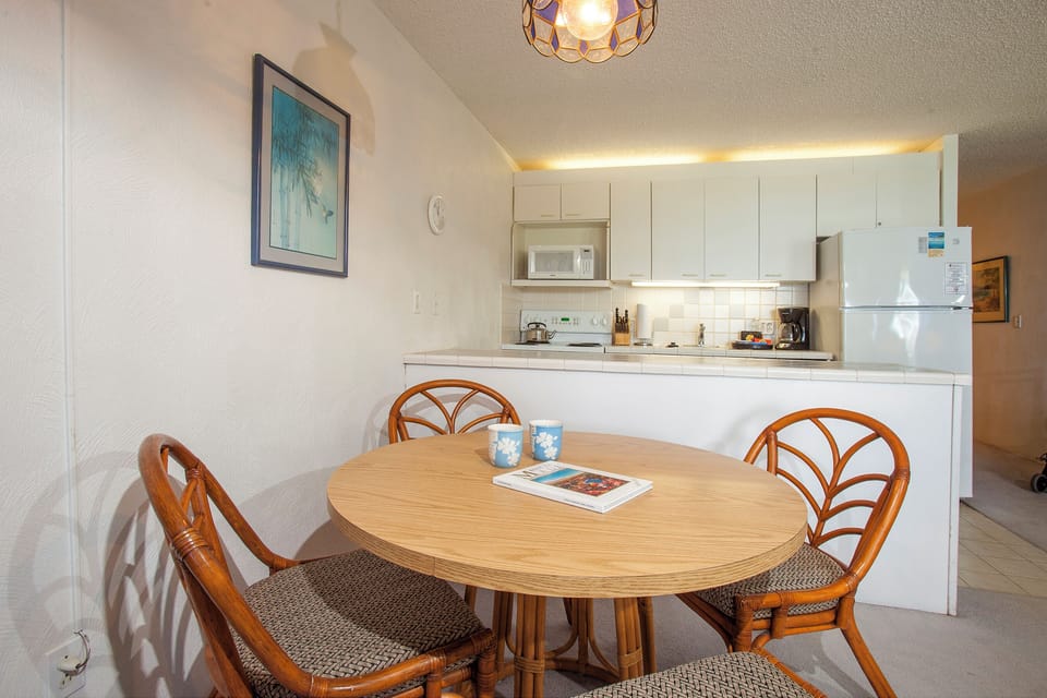Your cozy dining nook flows into a fully-equipped kitchen with everything you need for easy vacation meals, from the full-size fridge to the microwave and stove.