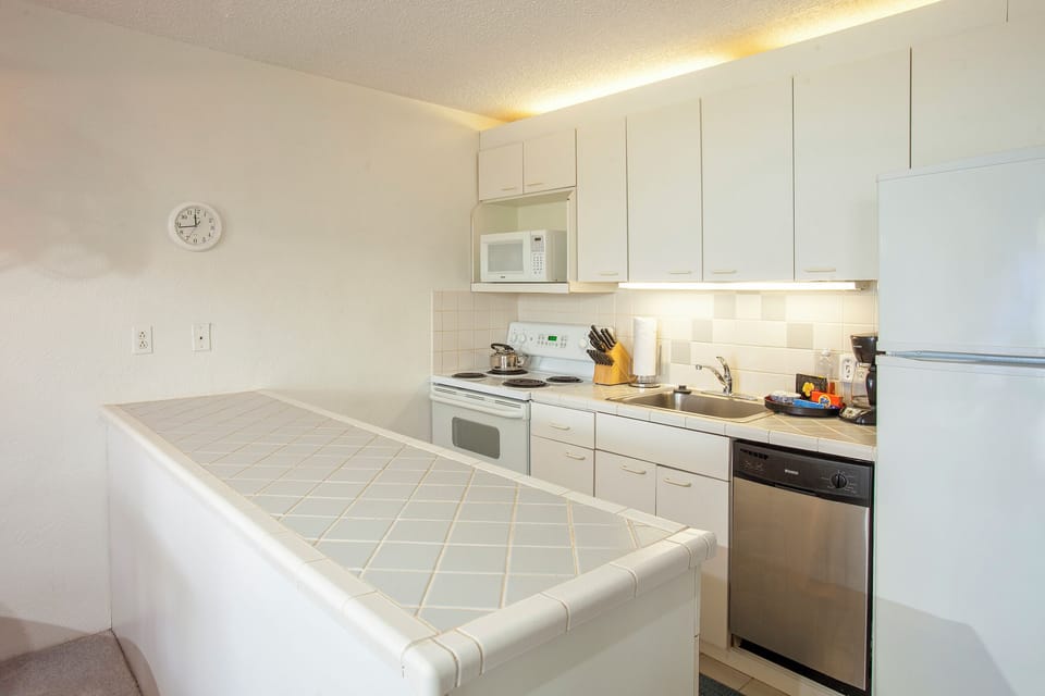Cook your favorite meals in this well-equipped kitchen featuring modern appliances, ample counter space, and everything you need for a comfortable stay.