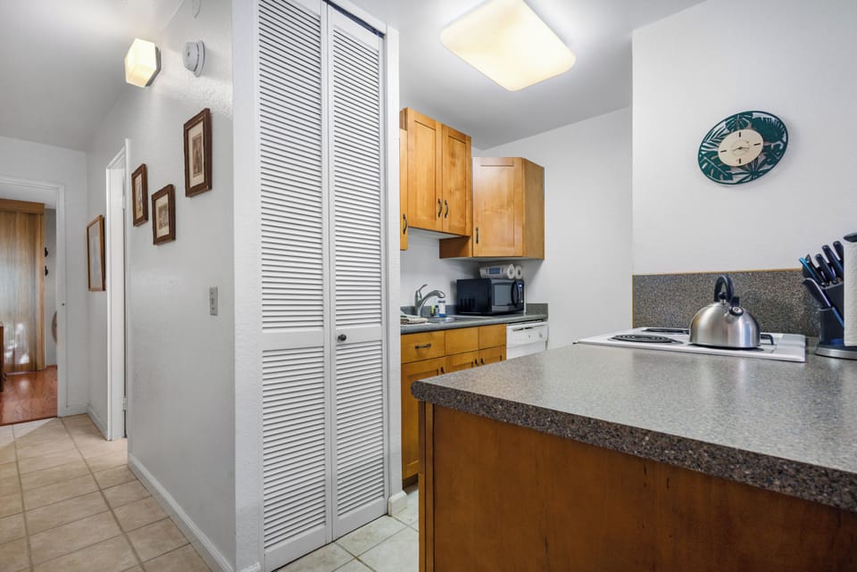 Your fully equipped kitchen features wooden cabinetry, granite countertops, and everything you need to prepare meals during your stay, from a gas stove to a microwave and dishwasher.