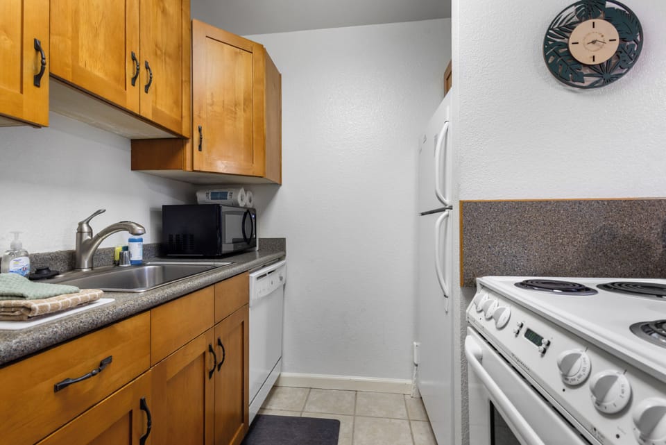 Your fully equipped kitchen includes everything you need to prepare meals during your stay, with a refrigerator, stove, microwave, and plenty of counter space for cooking and gathering.
