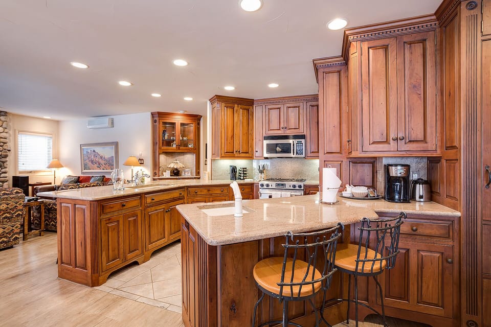 Your gourmet kitchen awaits with rich wood cabinetry, granite countertops, and modern appliances - perfect for creating memorable meals together.