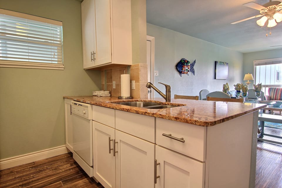 Your fully equipped kitchen features granite counters, modern appliances, and warm natural light—perfect for preparing meals during your stay.