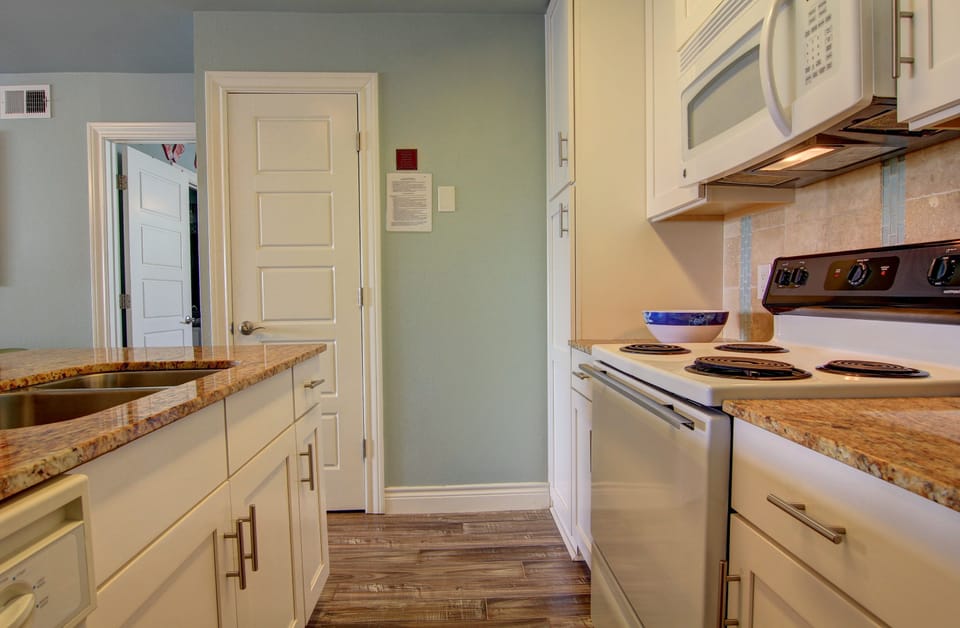 Your fully equipped kitchen features granite countertops and modern appliances, perfect for preparing home-cooked meals during your stay.