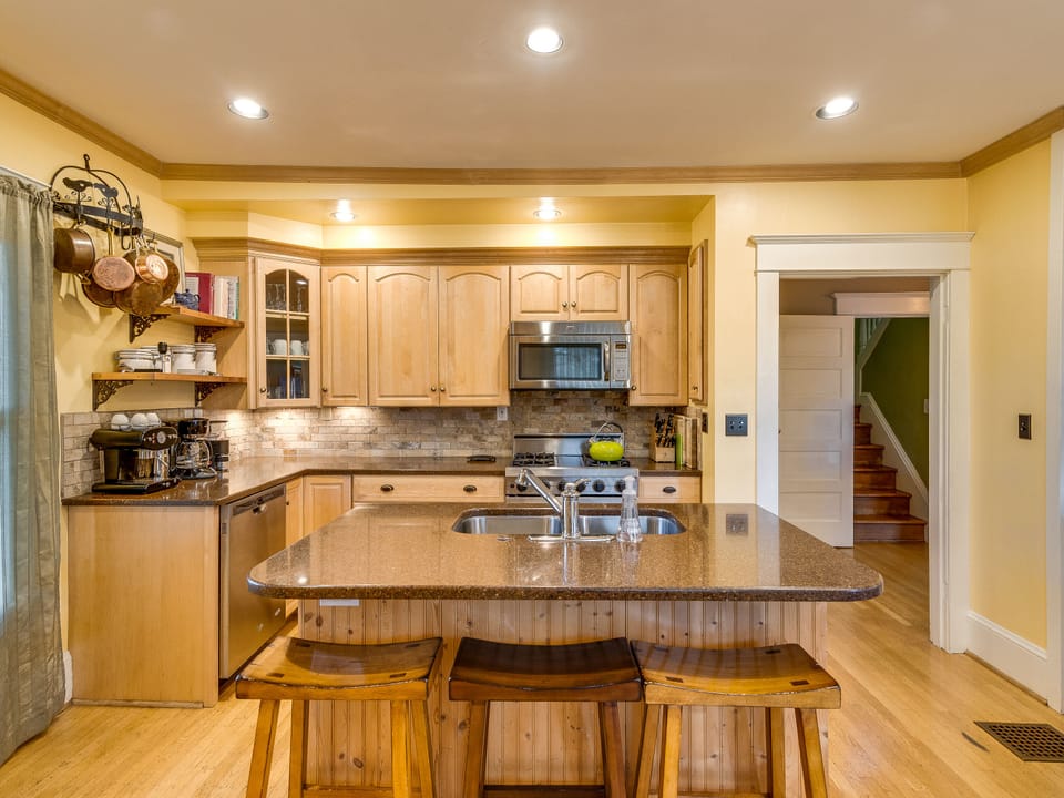 kitchen with stairway to attic in the background
