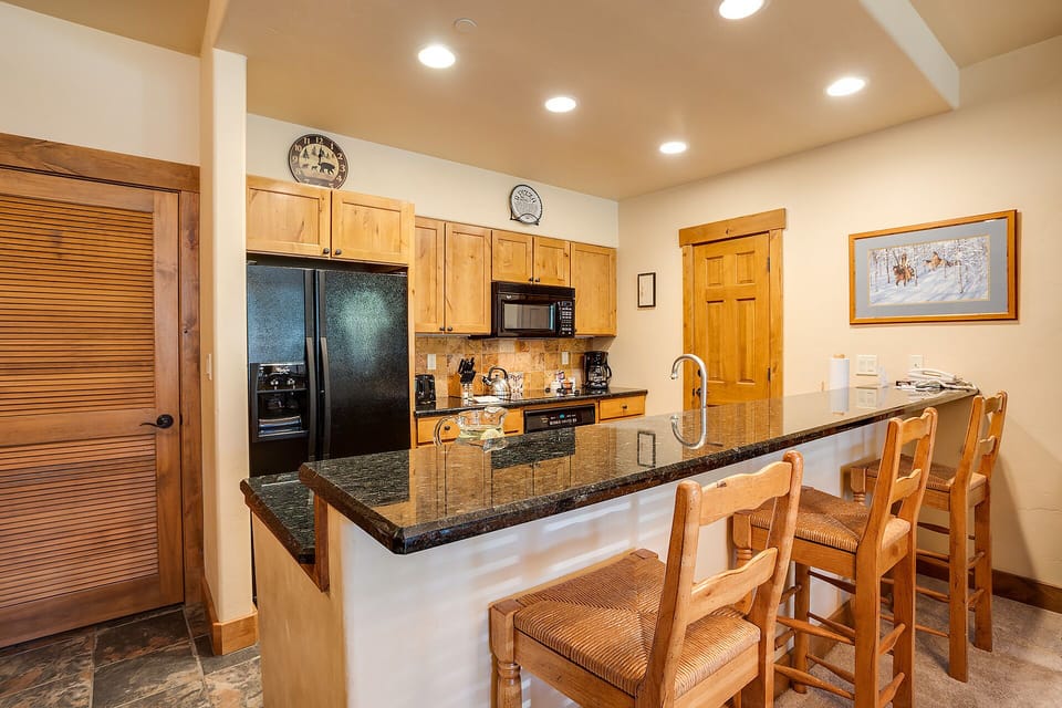 Gather around this spacious kitchen island for morning coffee and evening meals in your fully equipped mountain retreat.