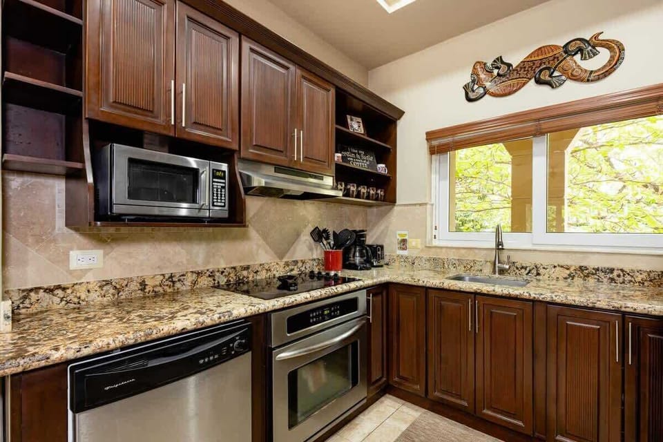 Kitchen featuring stainless steel appliances, granite countertops and wood cabinetry