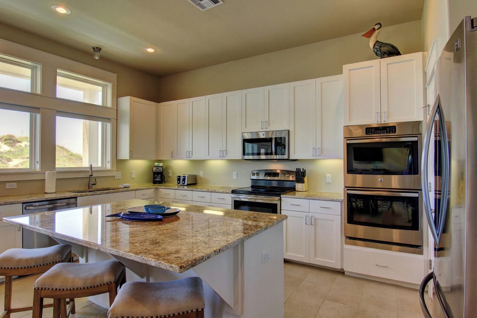 Your fully equipped kitchen features granite counters, stainless appliances, and breakfast bar seating for easy meal prep and casual dining.