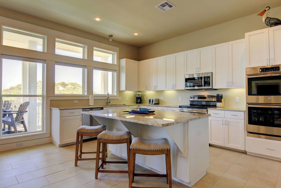 Cook memorable meals in your bright, fully-equipped kitchen featuring granite counters, stainless appliances, and a convenient breakfast island.