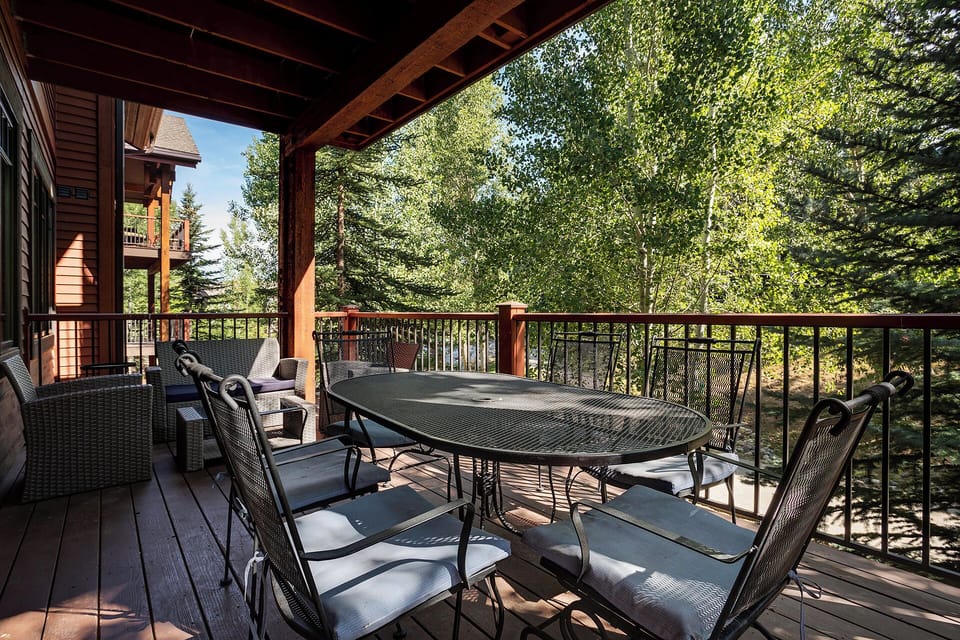 Step onto your private covered deck and gather around the spacious dining table while surrounded by lush forest views.