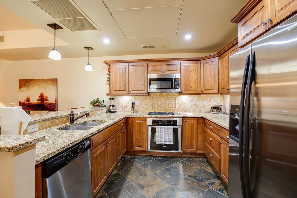 Your gourmet kitchen features granite counters, stainless steel appliances, and warm wood cabinets—perfect for creating memorable meals during your stay.