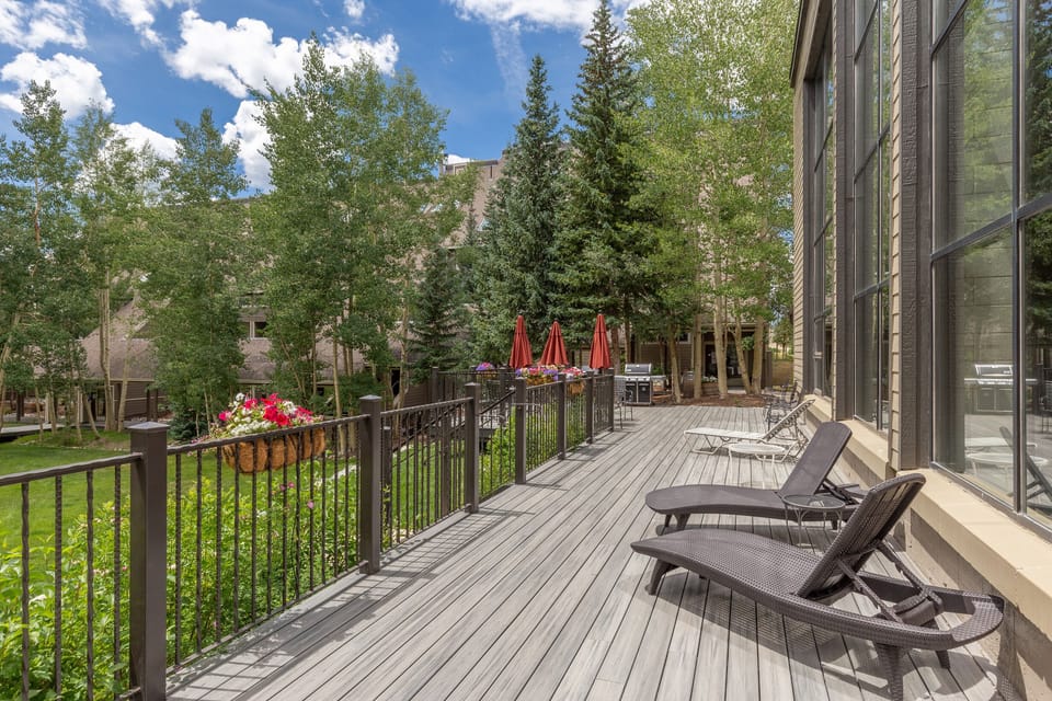 Stretch out on your private deck with lounge chairs, surrounded by tall aspens and mountain air. Bright flowers add charm to this peaceful outdoor retreat.