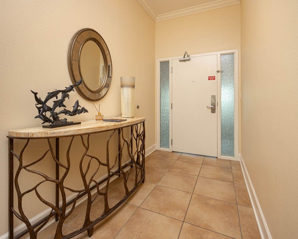 This welcoming entryway features a stylish console table, decorative mirror, and elegant accents, setting a relaxing tone