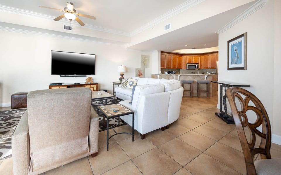 This living area features a large TV and comfortable seating, perfect for relaxing after a day at the beach
