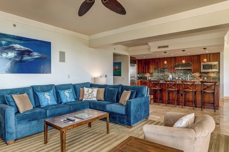 Elegant open-concept living with plush seating, island-inspired style, and panoramic views just beyond the glass doors