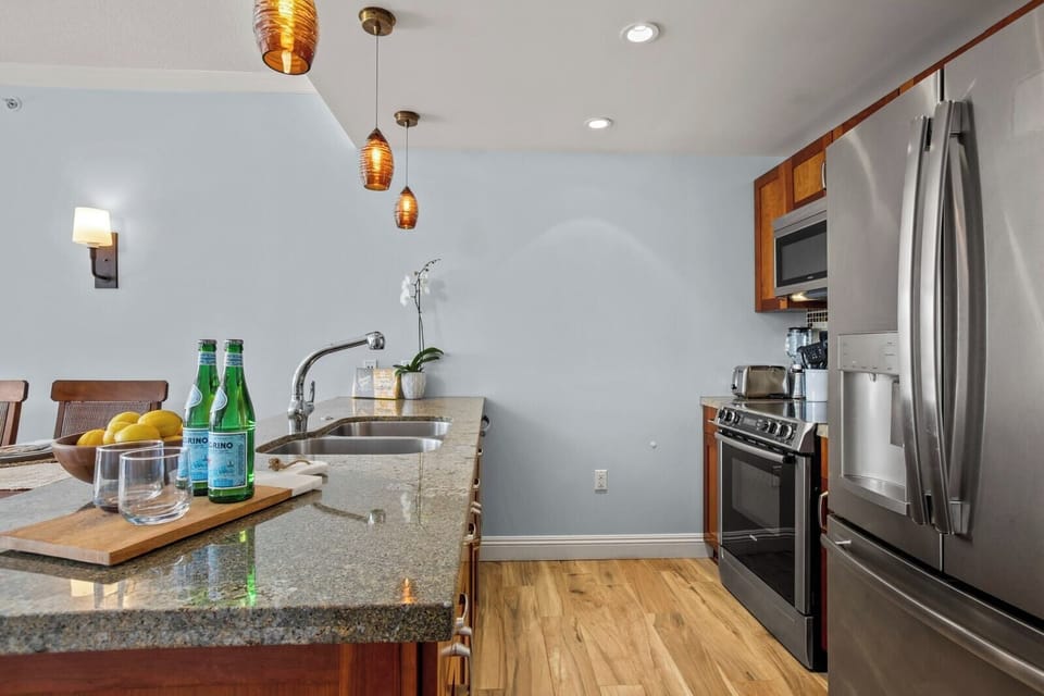 Modern island kitchen with stainless steel finishes and inviting ambiance.