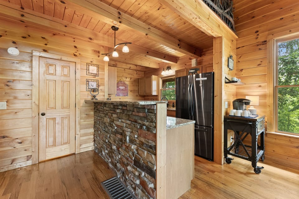 Fully equipped kitchen with modern conveniences and cabin charm.