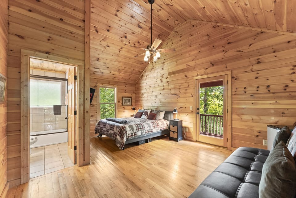 Open upstairs loft featuring a cozy king bed and full sleeper sofa — perfect for extra guests or a relaxing private retreat.