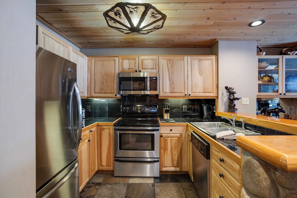 Your fully equipped kitchen features warm wood cabinets, granite countertops, and stainless steel appliances for memorable meal preparation.