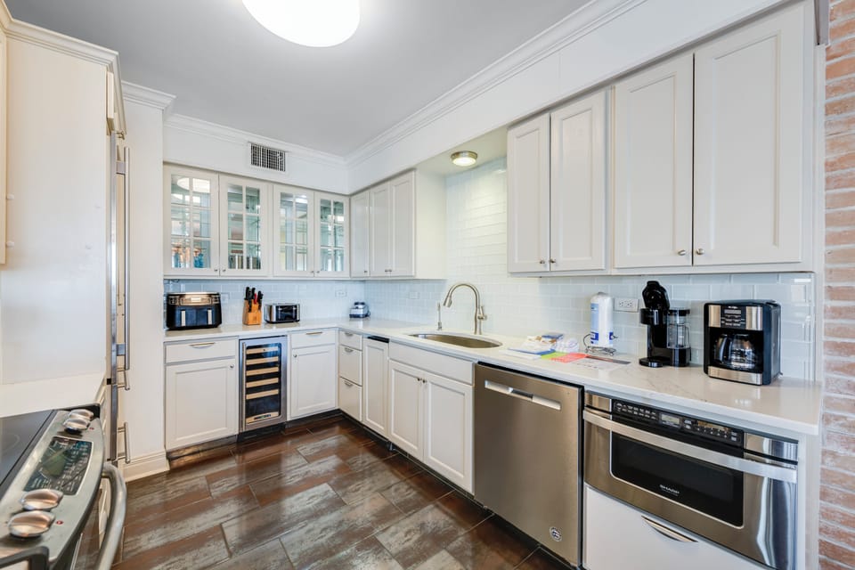 Your fully equipped gourmet kitchen features premium stainless steel appliances, elegant white cabinetry, and everything you need to create memorable meals during your stay.