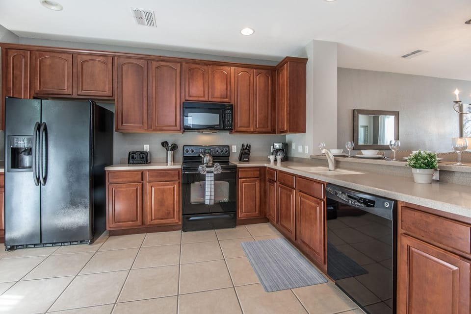 Step into the heart of the home, where an open concept kitchen awaits, fully furnished and featuring a sleek countertop table that beckons for casual meals, quick snacks, or lively conversations.