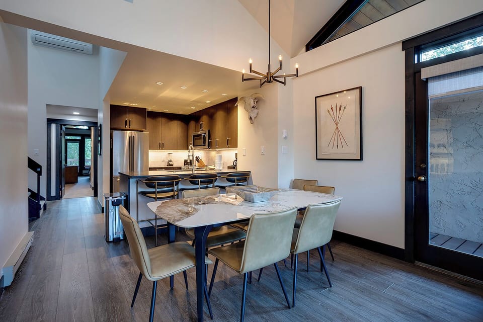Your elegant dining space features a marble table and modern kitchen, perfect for memorable meals together.