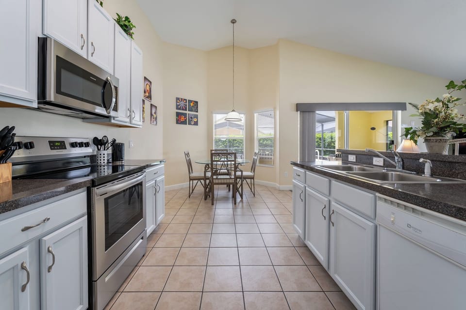View from kitchen overlooking  the breakfast nook and pool.