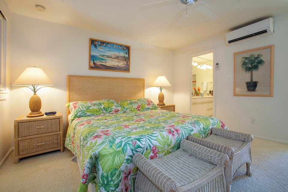 Your tropical retreat awaits with a plush bed dressed in vibrant island florals, soft ambient lighting, and cool air conditioning. Unwind in this peaceful space where every detail invites relaxation and comfort.