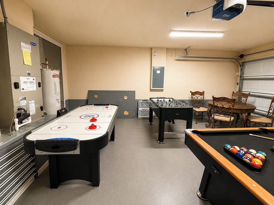 Game room showing Air hockey table, foosball table, and pool table.