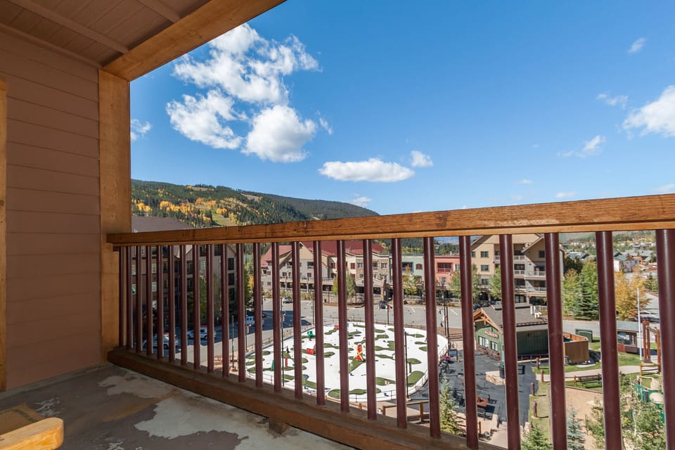 Stunning mountain and village views from your private balcony, with golden autumn foliage creating a picturesque backdrop for your stay.