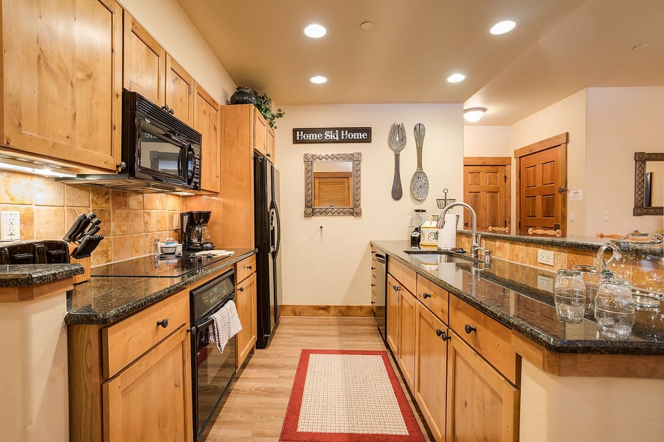Your fully equipped kitchen awaits with granite countertops, warm wood cabinets, and all the appliances you need to create memorable meals.