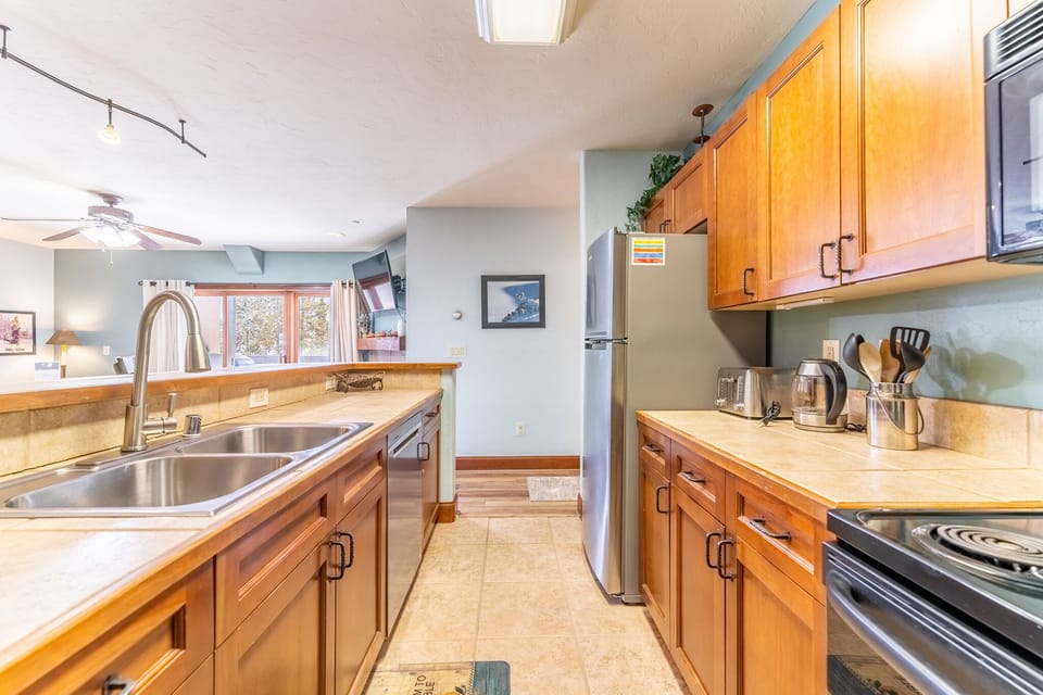 Your spacious kitchen features warm wood cabinets, granite counters, and everything you need to create memorable meals during your stay.