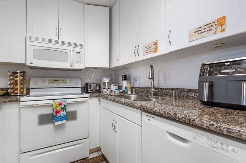 Prepare your favorite meals in this fully equipped kitchen featuring granite countertops, modern appliances, and everything you need for a comfortable stay.