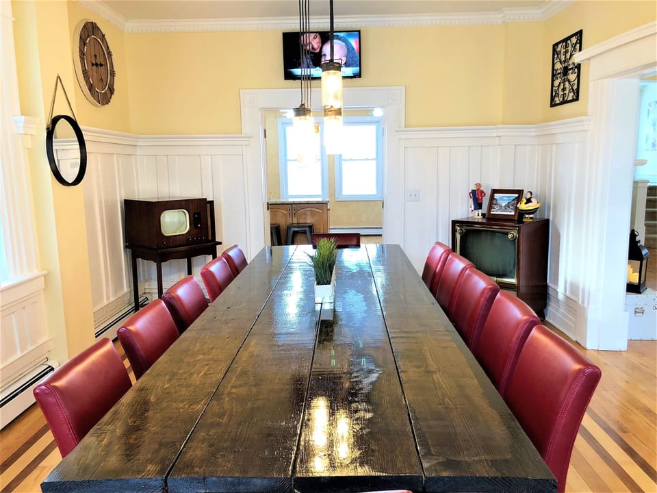 custom made dining table with mirrored televisions & open to the kitchen