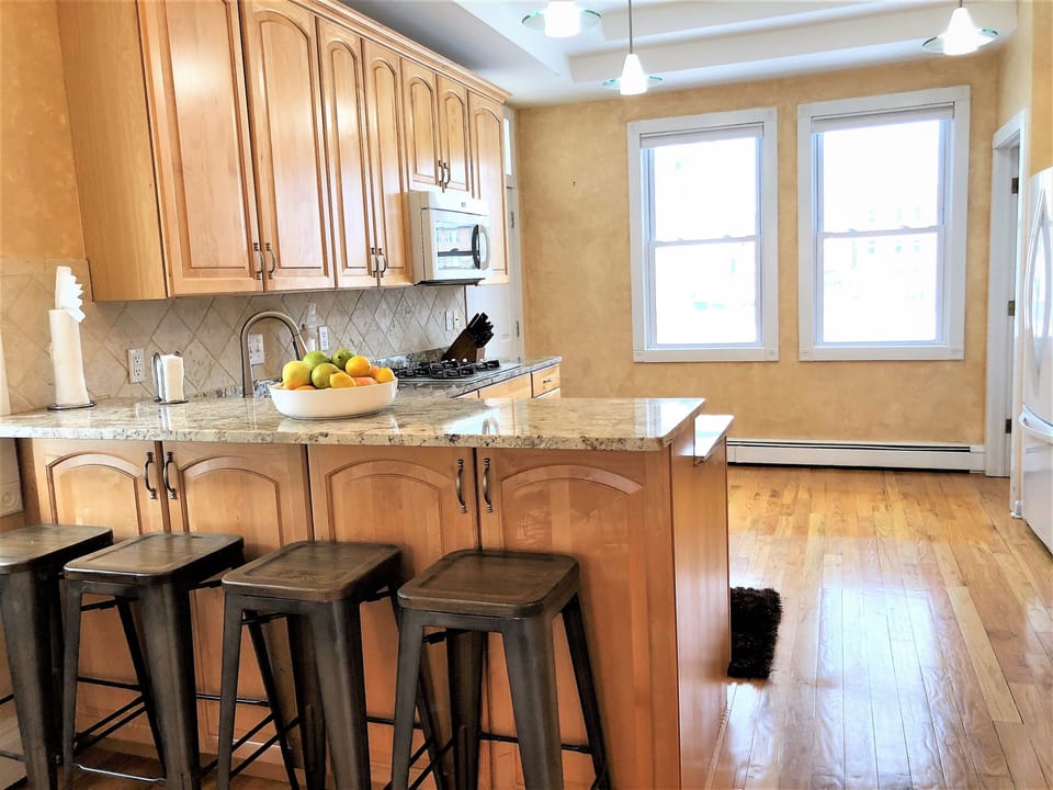 Granite counter, double oven, bar counter top, sitting area, open to dining room