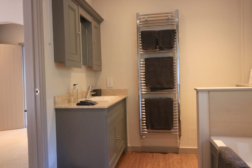 Ensuite vanity with marble top and heated towel rail