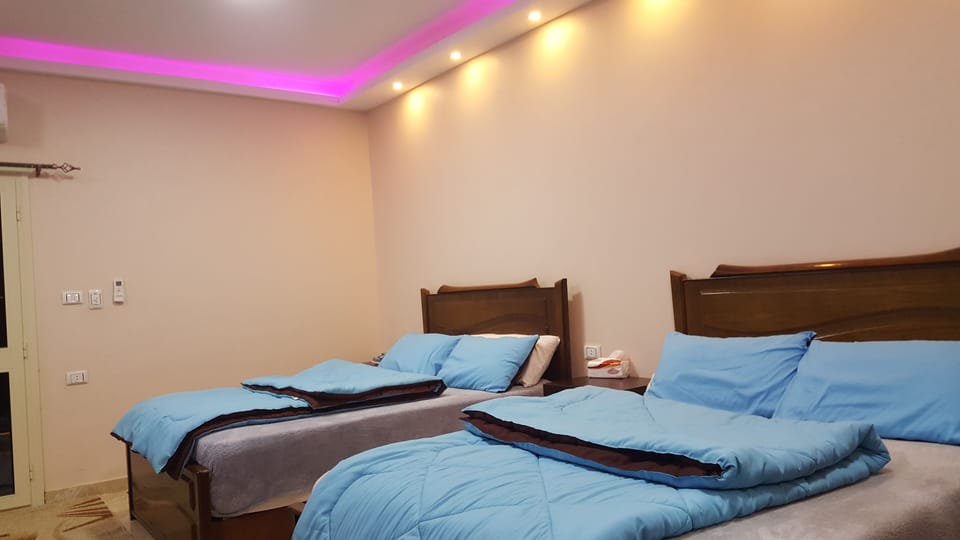 Comfort Quadruple Room, 2 Queen Beds, Mountain View | Individually decorated, laptop workspace, blackout drapes, soundproofing