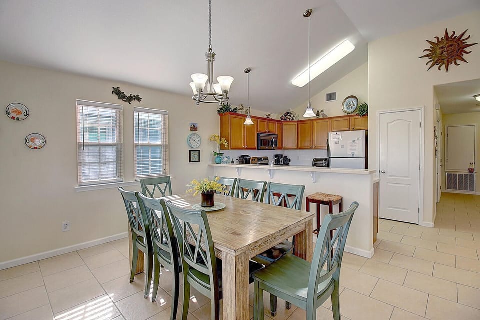 Gather around your spacious dining table where natural light streams through large windows, creating the perfect spot for memorable meals together.