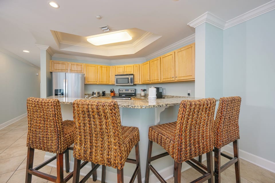 Gather around the inviting breakfast bar, perfect for sharing laughter and plans while enjoying coastal vibes