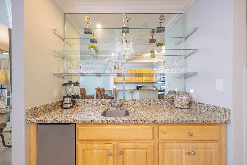 Craft refreshing drinks at the wet bar, surrounded by thoughtful decor and a cozy vibe for family gatherings