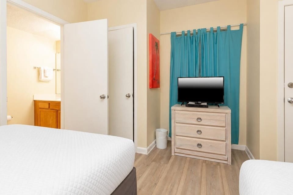 Relax in the comfortable guest room featuring queen beds, a TV, and cheerful decor that enhances your stay