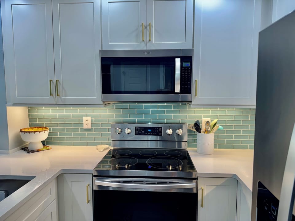 Very nice appliances and look at that precious back splash and cabinets to the ceiling!