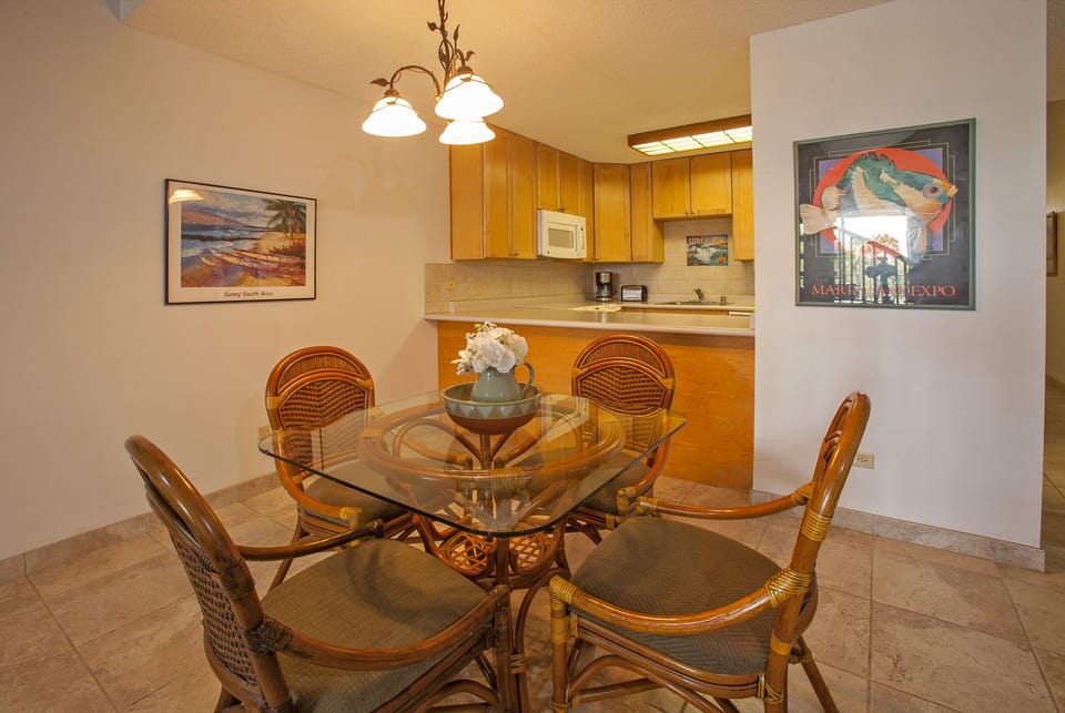 Gather around this inviting dining space with elegant glass-top table and tropical-inspired seating. Your fully-equipped kitchen awaits, perfect for preparing fresh local flavors in warm island ambiance.
