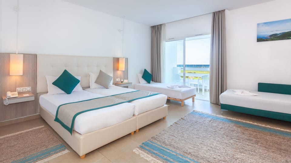 Standard Quadruple Room | Minibar, in-room safe, desk, blackout drapes