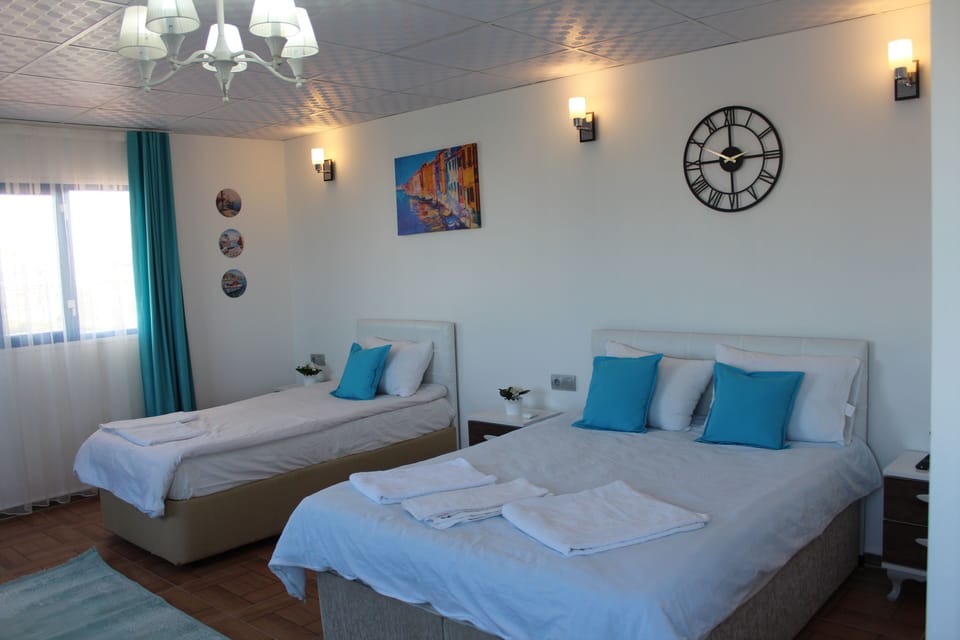 Economy Triple Room, 1 Bedroom, Non Smoking, Partial Sea View | Individually decorated, individually furnished, desk, laptop workspace