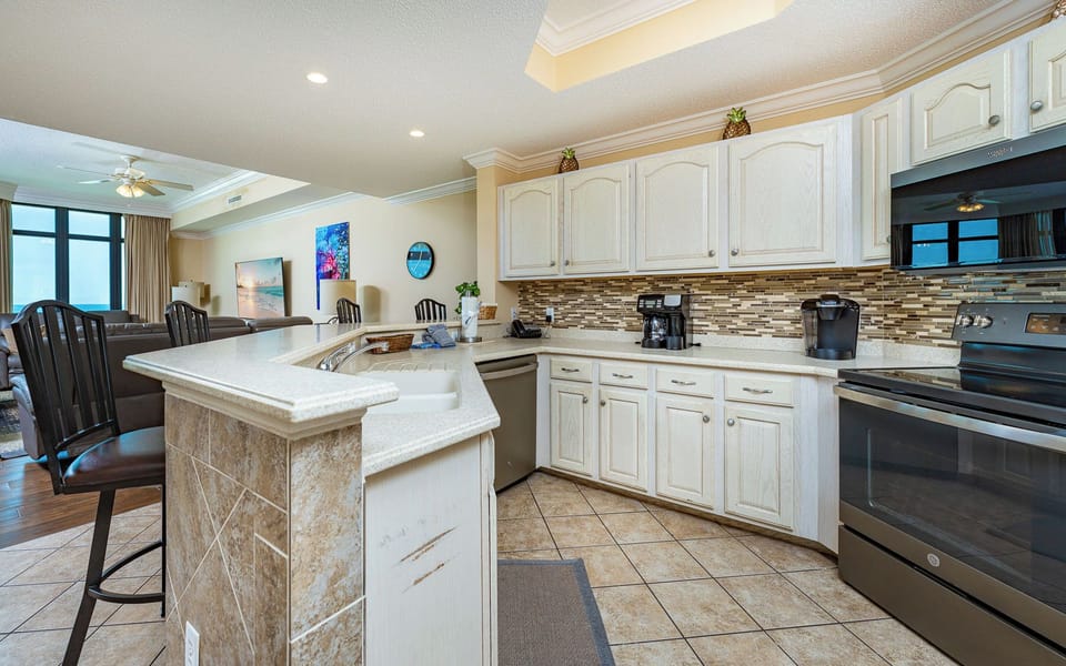 Imagine preparing fresh snacks at the breakfast bar while chatting with family in the open living room nearby