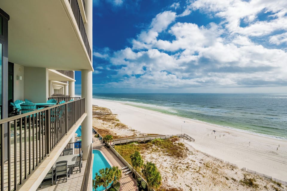 Enjoy stunning beach views from the balcony, complete with comfortable seating for relaxation