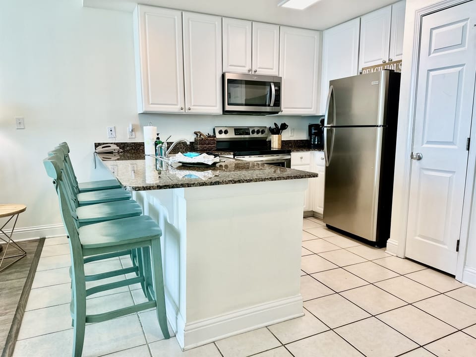 This fully stocked kitchen features updated stainless appliances...and seating for four at the bar.
