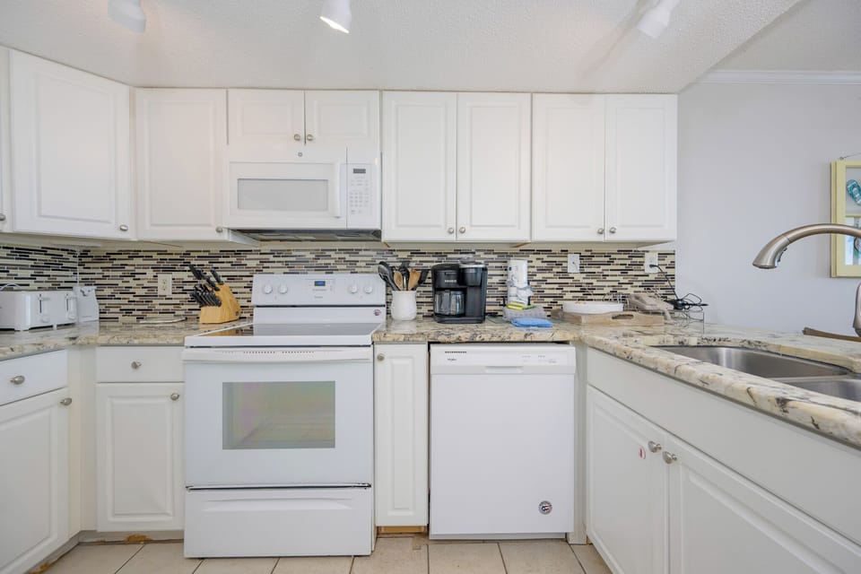 Whip up your favorite beach snacks in the charming kitchen, enjoying the seamless flow of family conversations