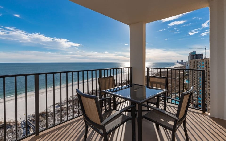 Balcony seating offers a serene view of the beach and tranquil gulf waters, perfect for relaxing or enjoying meals outdoors