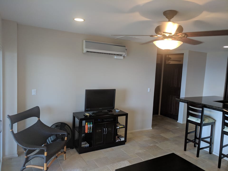 TV with cable in living room.  AC unit